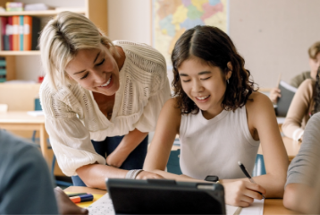 teacher assisting student on assignment